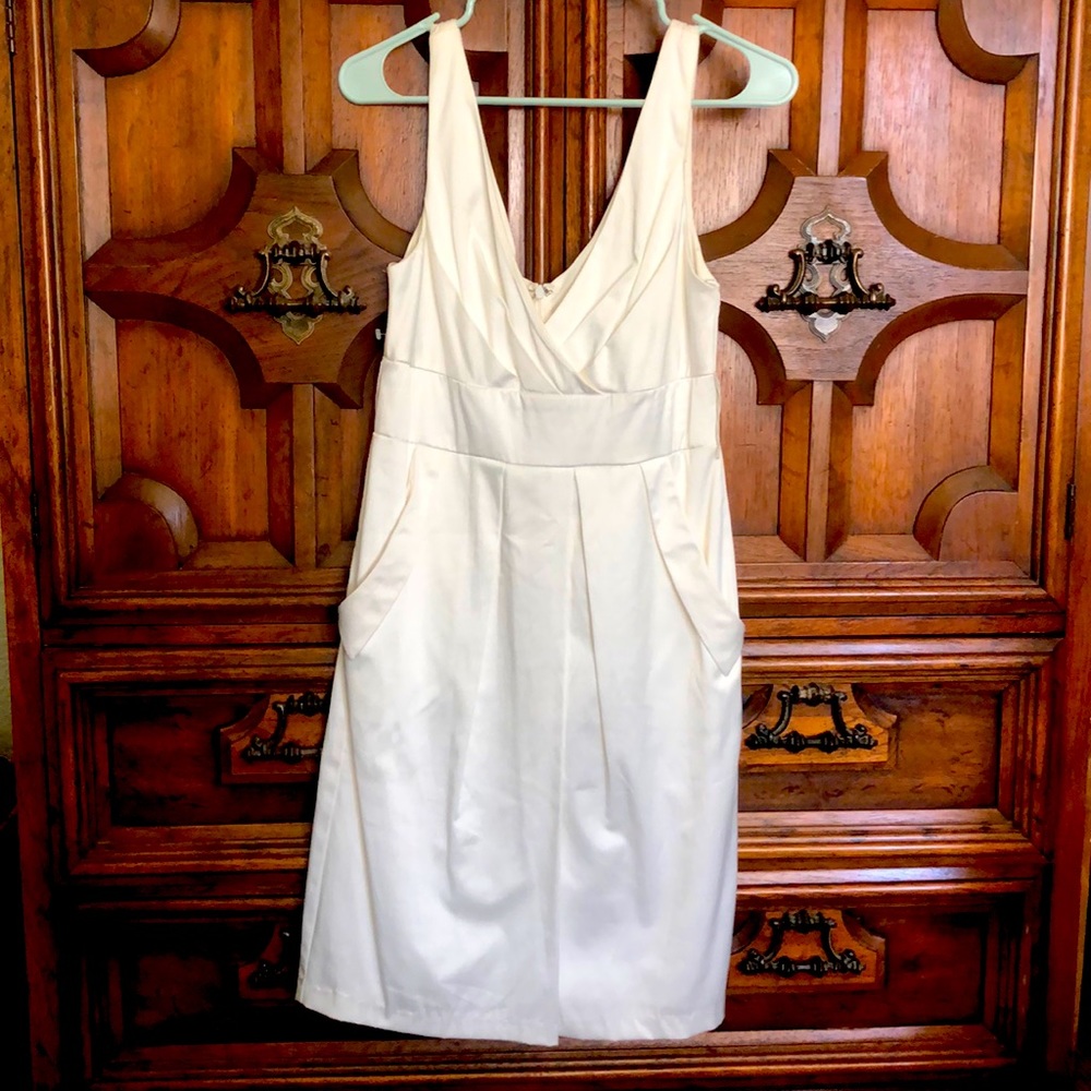 Size 8 white dress with pockets. Never worn. Beautiful satin finish.